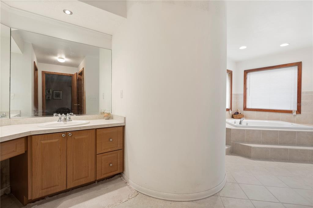 18321 McMullen Road Spring Hill, FL 34610 - Photo 41 of 56 a bathroom with a double vanity sink and mirror
