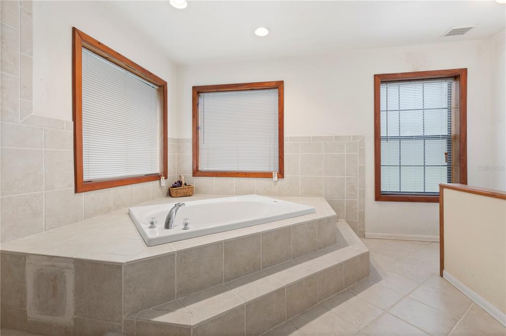 18321 McMullen Road Spring Hill, FL 34610 - Photo 42 of 56 a bathroom with a bathtub and a sink