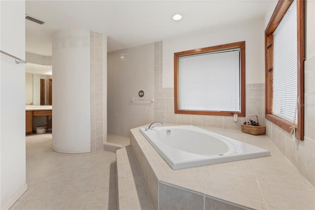 18321 McMullen Road Spring Hill, FL 34610 - Photo 43 of 56 a bathroom with a tub sink and mirror