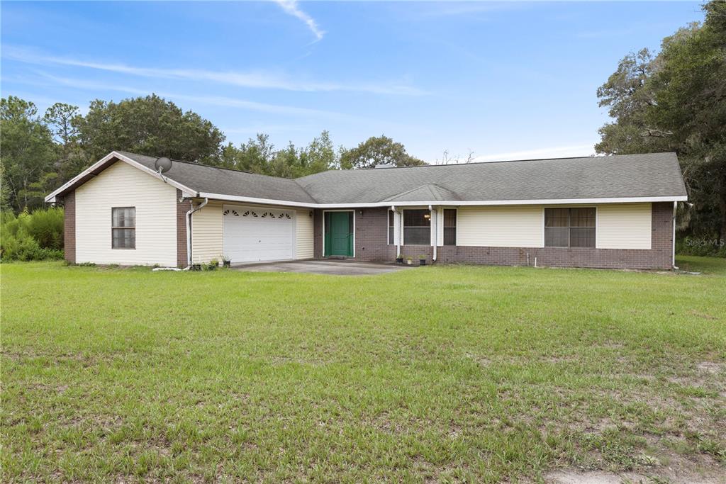 18321 McMullen Road Spring Hill, FL 34610 - Photo 48 of 56 a view of a house with a backyard