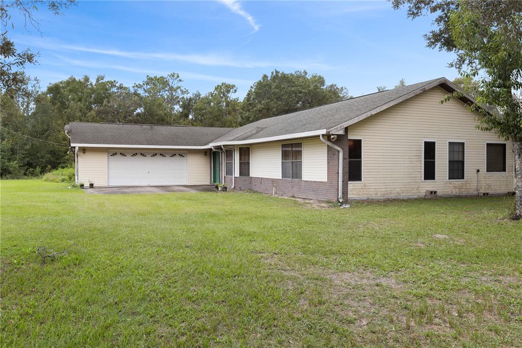 18321 McMullen Road Spring Hill, FL 34610 - Photo 51 of 56 a view of a house with a backyard