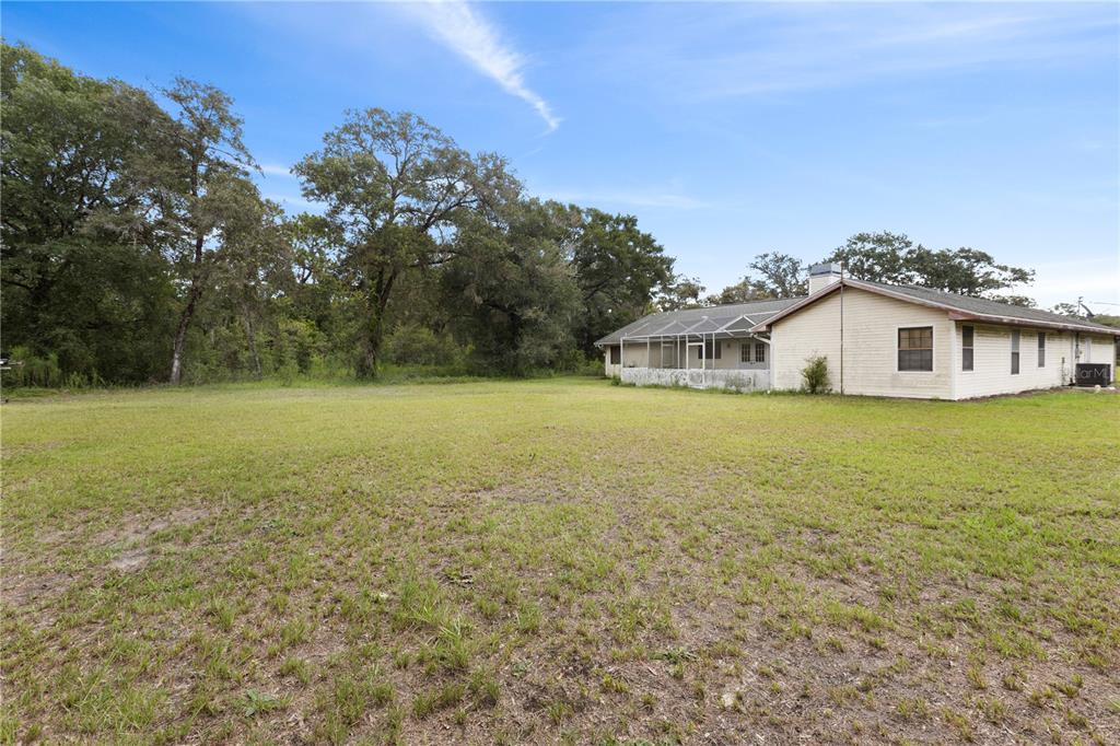 18321 McMullen Road Spring Hill, FL 34610 - Photo 54 of 56 a view of a house with a yard