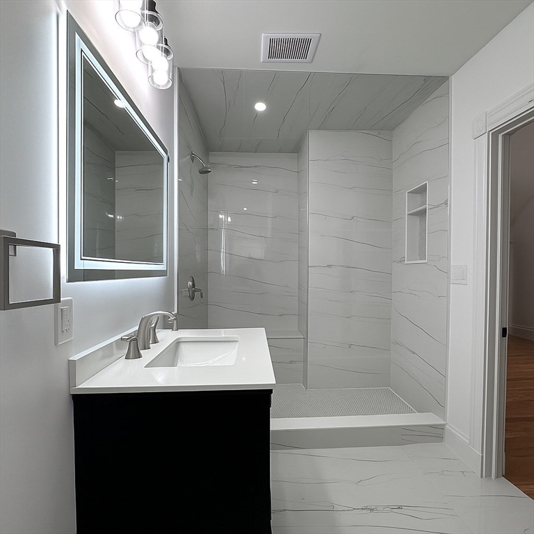 70 Nelson Street, Unit 2 Boston, MA 02124 - Photo 11 of 12 a bathroom with a sink mirror toilet and bathtub