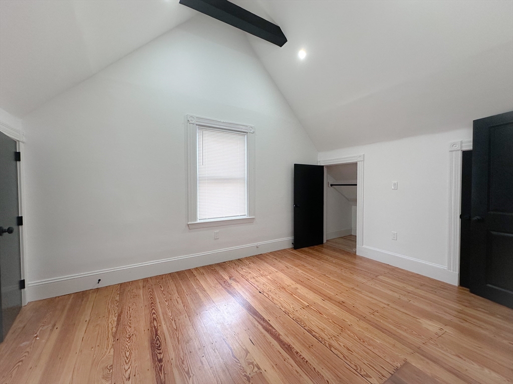70 Nelson Street, Unit 2 Boston, MA 02124 - Photo 7 of 12 wooden floor in an empty room with a window