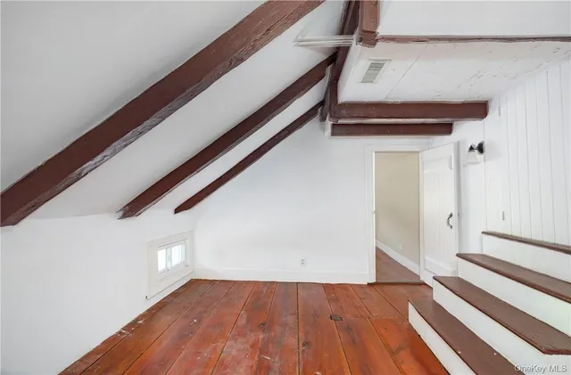 a view of entryway with wooden floor and stairs