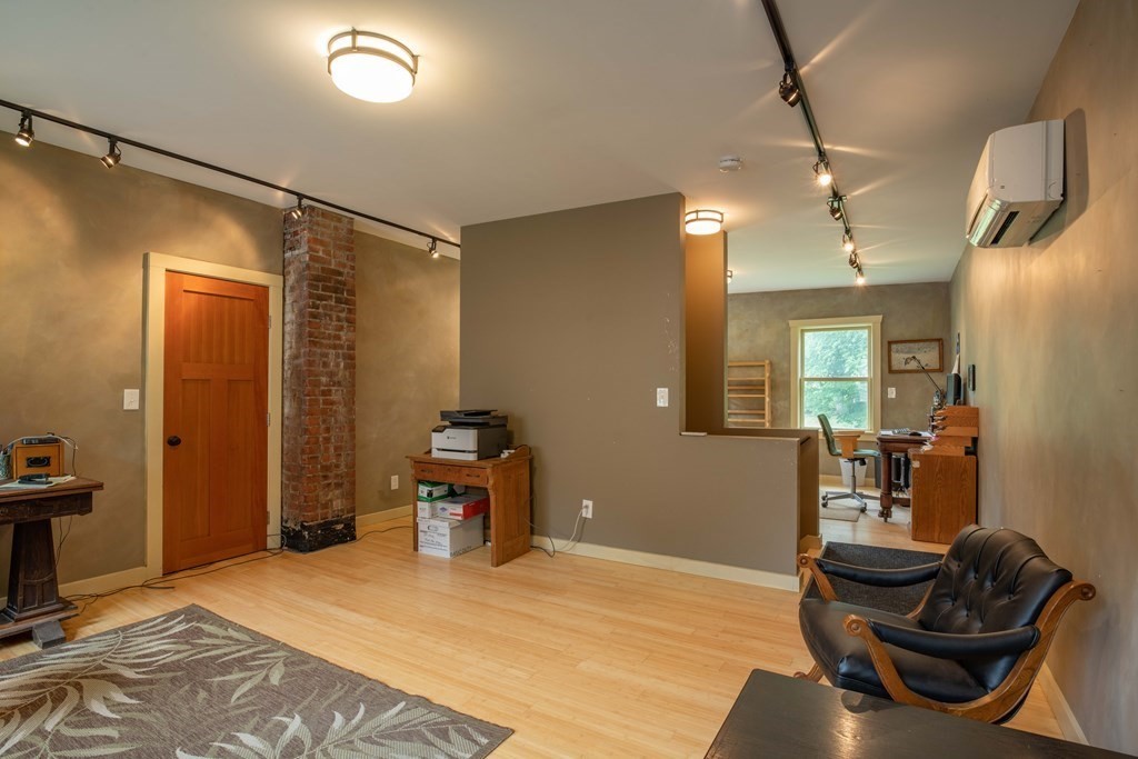 25 Amherst Road Pelham, MA 01002 - Photo 18 of 22 a bedroom with a bed and wooden floor