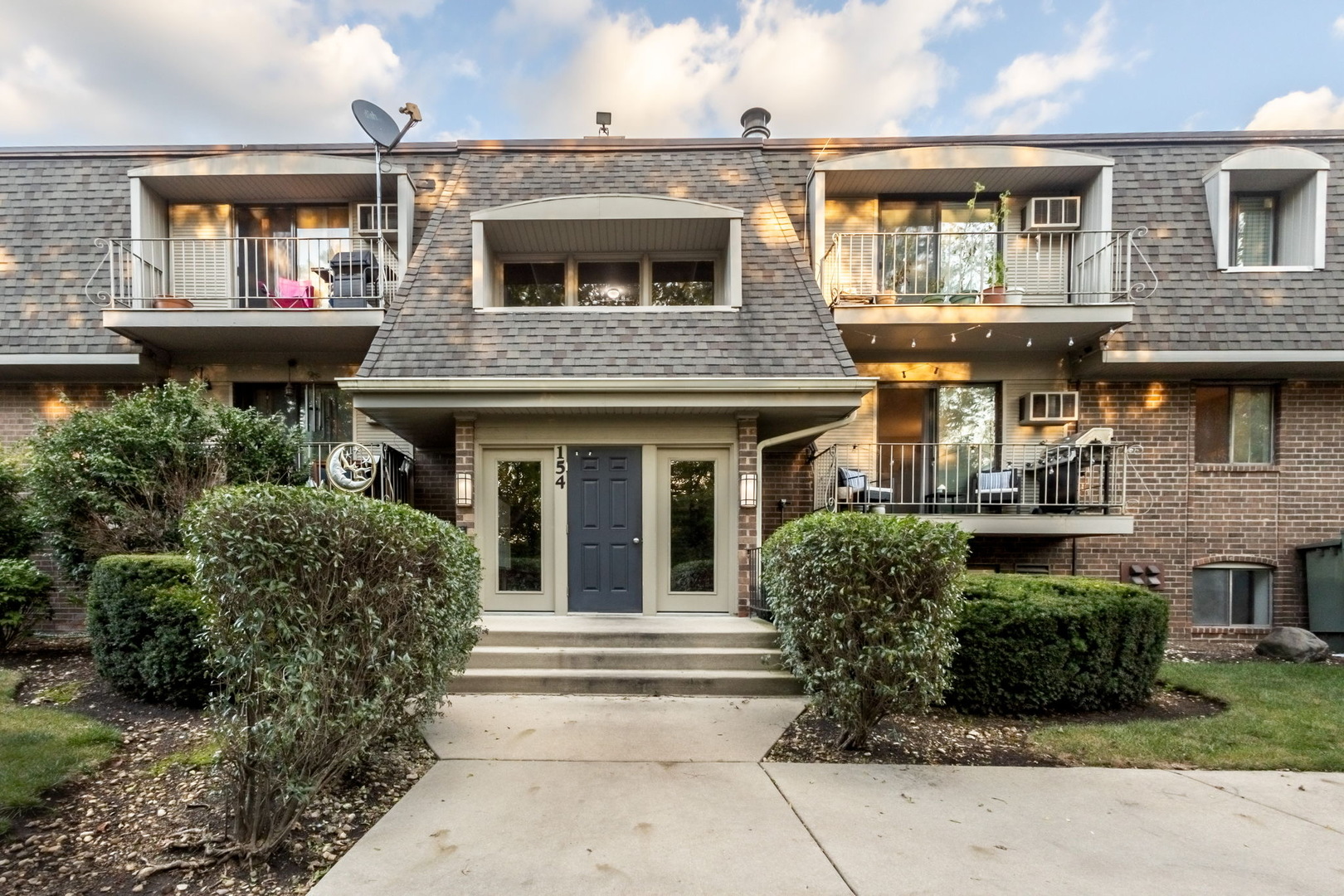 154 East Bailey Road, Unit F Naperville, IL 60565 - Photo 1 of 25 a front view of a house with a garden