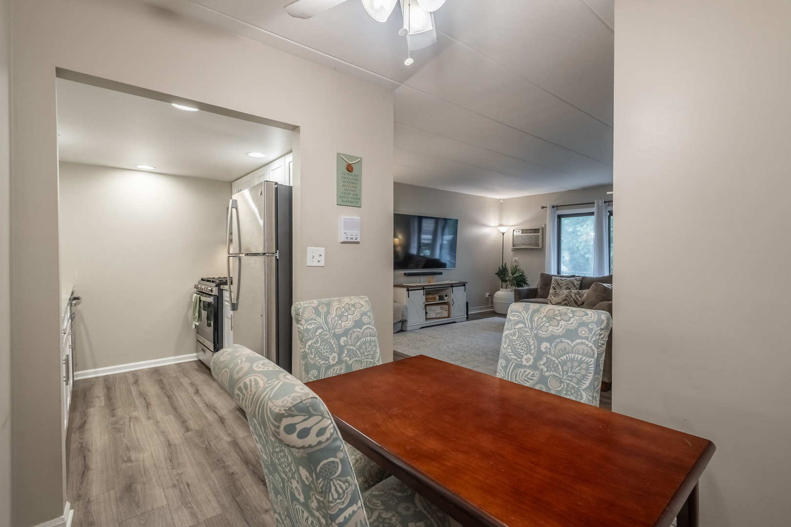 154 East Bailey Road, Unit F Naperville, IL 60565 - Photo 11 of 25 a living room with furniture a flat screen tv and a table