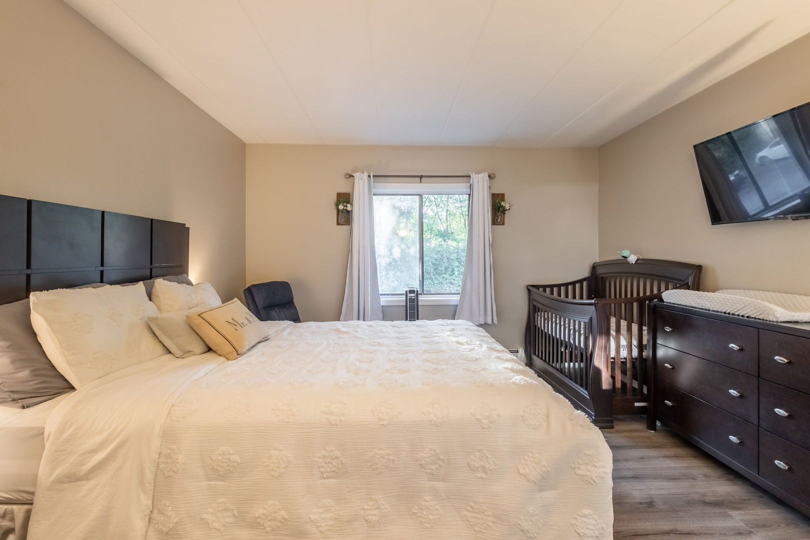 154 East Bailey Road, Unit F Naperville, IL 60565 - Photo 17 of 25 a bedroom with a bed and dresser with mirror