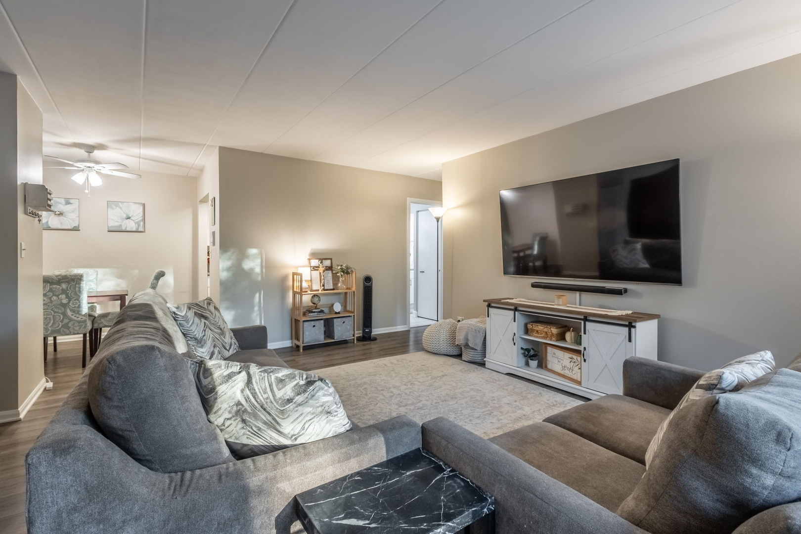 154 East Bailey Road, Unit F Naperville, IL 60565 - Photo 2 of 25 a living room with furniture and a flat screen tv