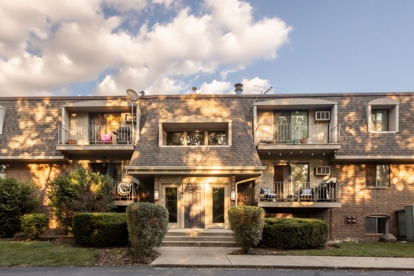 154 East Bailey Road, Unit F Naperville, IL 60565 - Photo 25 of 25 a front view of a residential apartment building with a yard