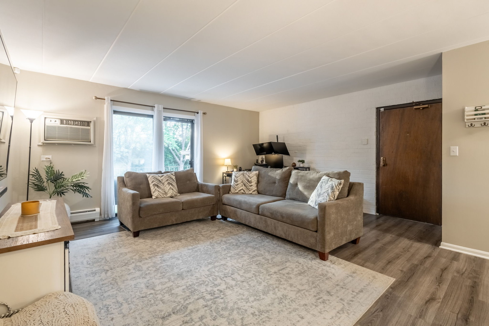 154 East Bailey Road, Unit F Naperville, IL 60565 - Photo 4 of 25 a living room with furniture and a large window