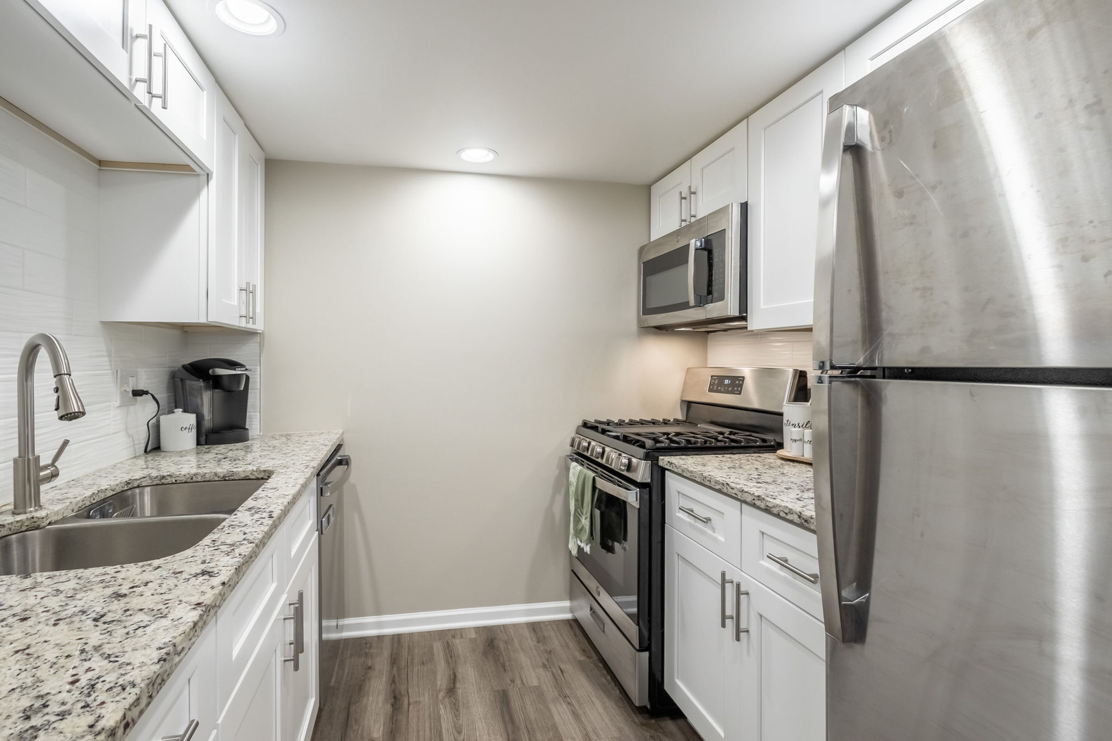154 East Bailey Road, Unit F Naperville, IL 60565 - Photo 7 of 25 a kitchen with stainless steel appliances granite countertop a sink stove and refrigerator