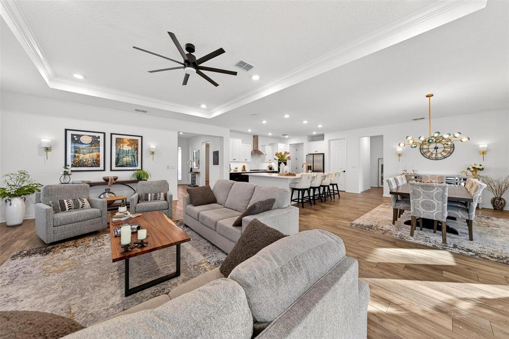 9746 Southwest 108th Terrace Road Ocala, FL 34481 - Photo 18 of 99 a living room with furniture a clock and a ceiling fan