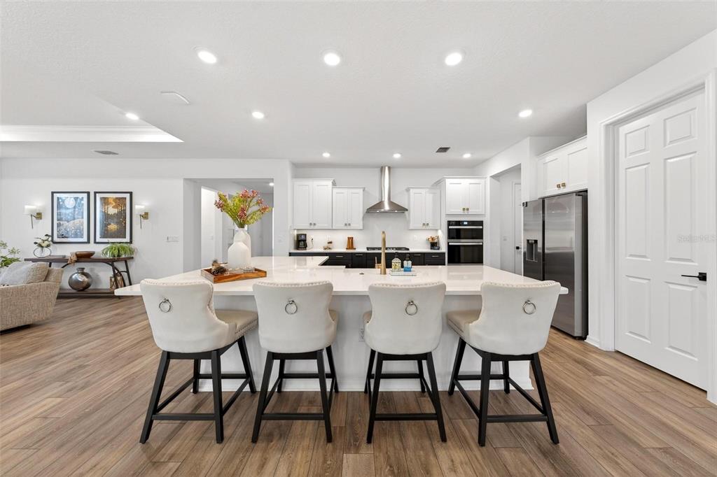 9746 Southwest 108th Terrace Road Ocala, FL 34481 - Photo 23 of 99 a kitchen with stainless steel appliances a dining table chairs and wooden floor