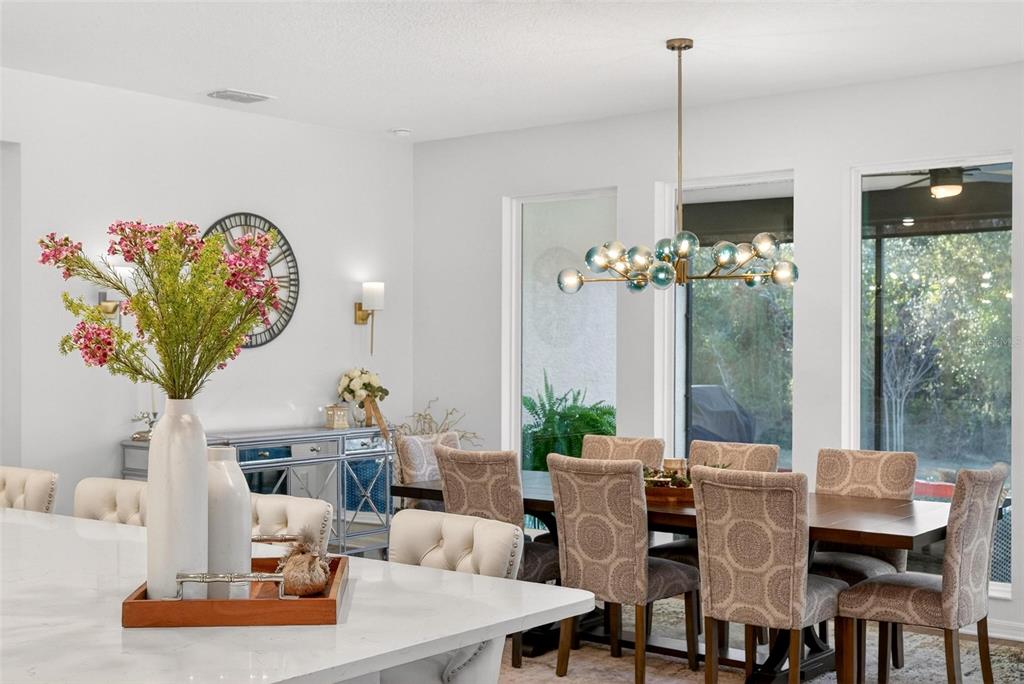 9746 Southwest 108th Terrace Road Ocala, FL 34481 - Photo 35 of 99 a living room with furniture flowers and a chandelier