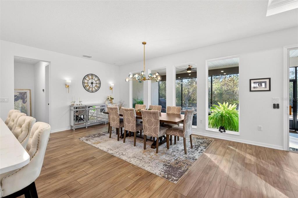 9746 Southwest 108th Terrace Road Ocala, FL 34481 - Photo 36 of 99 a view of a dining room with furniture window and wooden floor