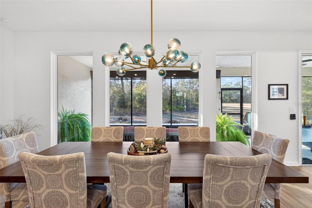 9746 Southwest 108th Terrace Road Ocala, FL 34481 - Photo 40 of 99 a view of a dining room with furniture a chandelier and windows