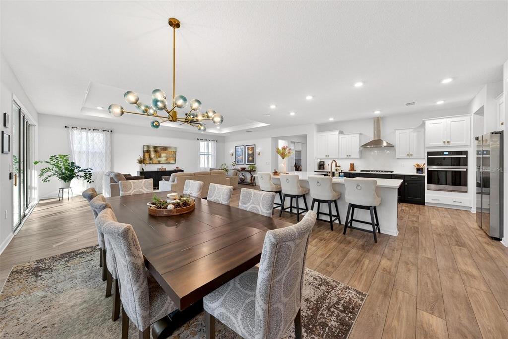 9746 Southwest 108th Terrace Road Ocala, FL 34481 - Photo 42 of 99 a view of a dining room and livingroom with furniture wooden floor a chandelier