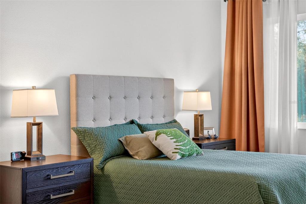 9746 Southwest 108th Terrace Road Ocala, FL 34481 - Photo 47 of 99 a bedroom with a bed and a lamp