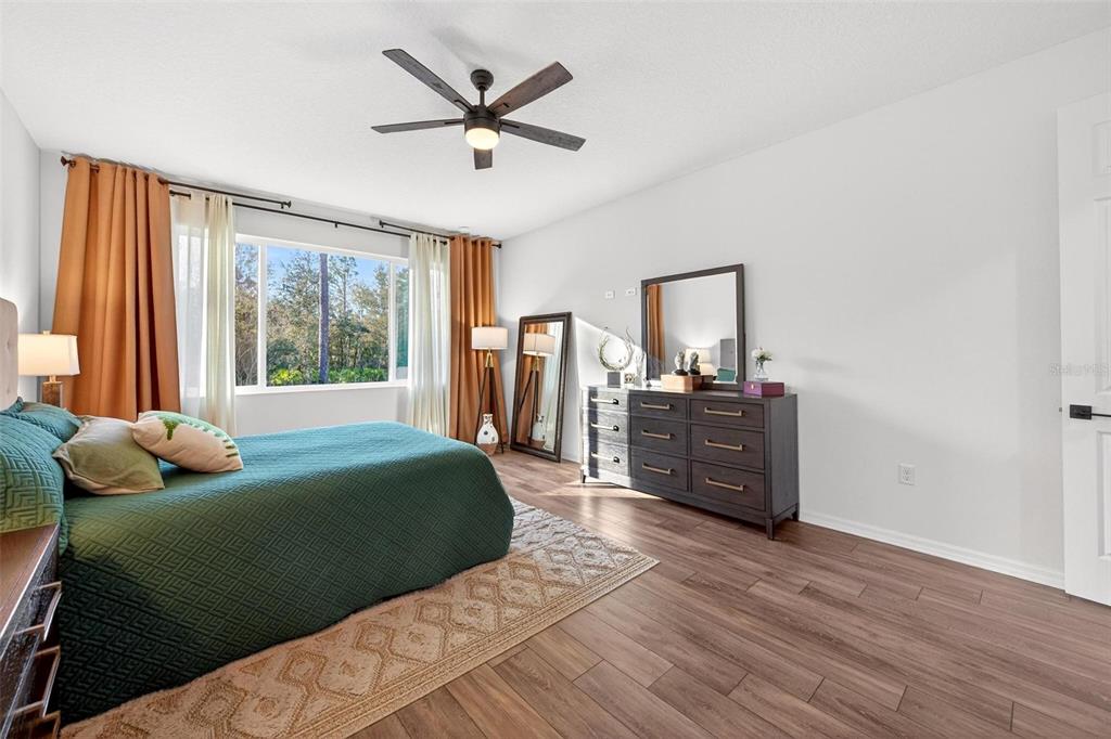 9746 Southwest 108th Terrace Road Ocala, FL 34481 - Photo 50 of 99 a bedroom with a bed and wooden floor