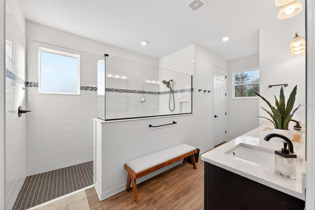 9746 Southwest 108th Terrace Road Ocala, FL 34481 - Photo 51 of 99 a bathroom with a sink a mirror and a shower