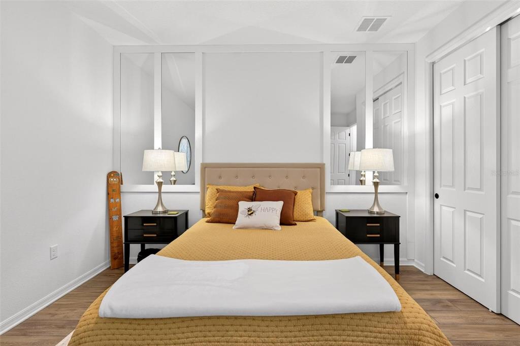 9746 Southwest 108th Terrace Road Ocala, FL 34481 - Photo 63 of 99 a bedroom with a bed and wooden floor