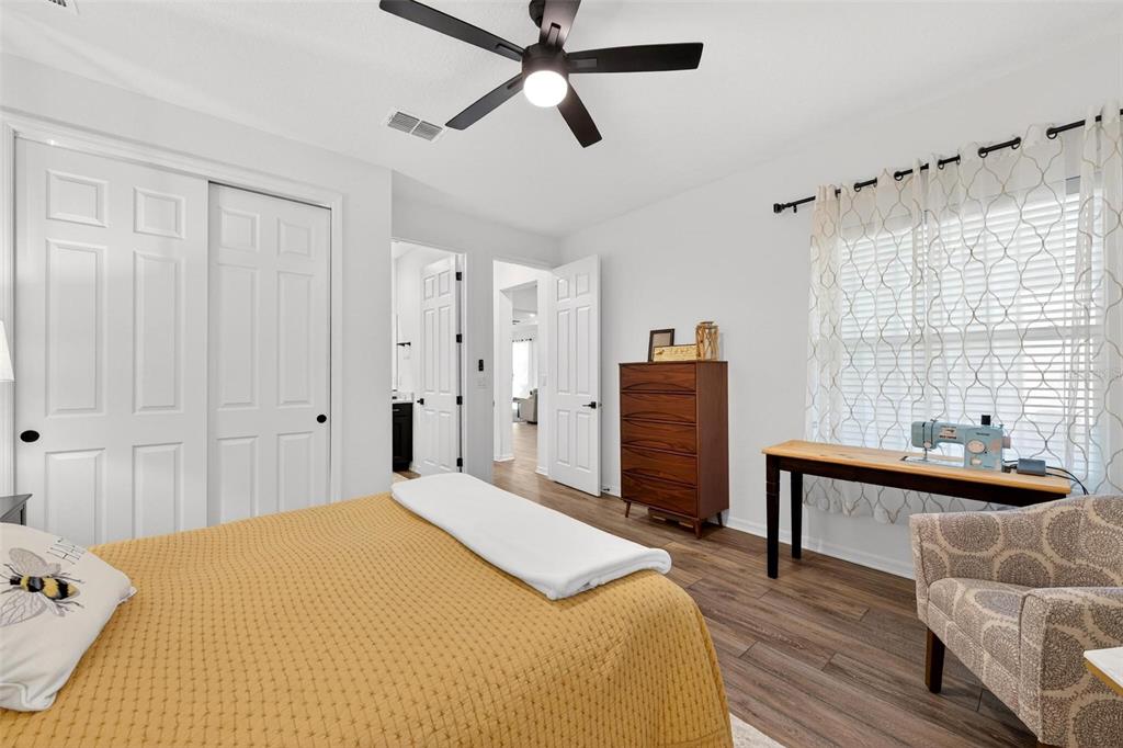 9746 Southwest 108th Terrace Road Ocala, FL 34481 - Photo 65 of 99 a bedroom with a bed and a chandelier