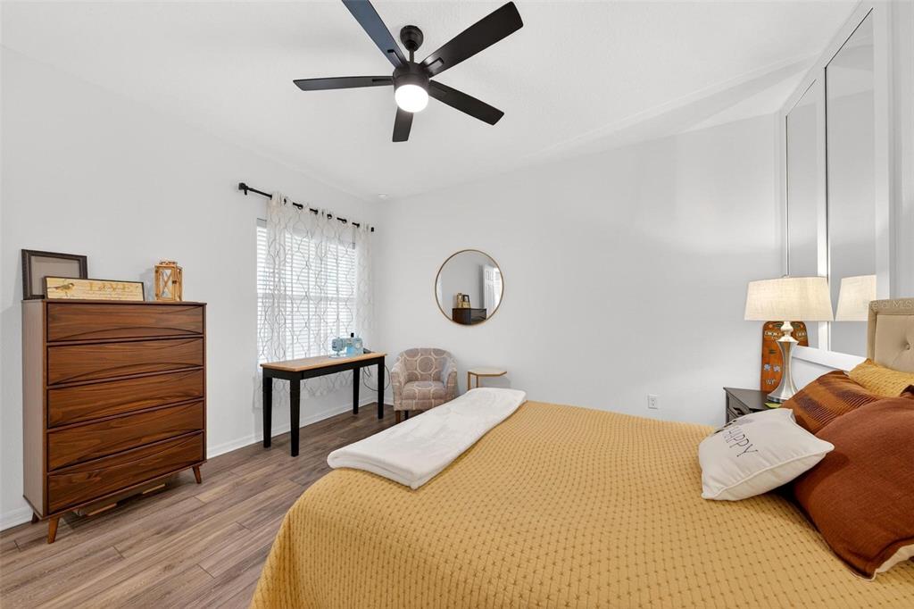 9746 Southwest 108th Terrace Road Ocala, FL 34481 - Photo 66 of 99 a bedroom with a bed a dresser and chair