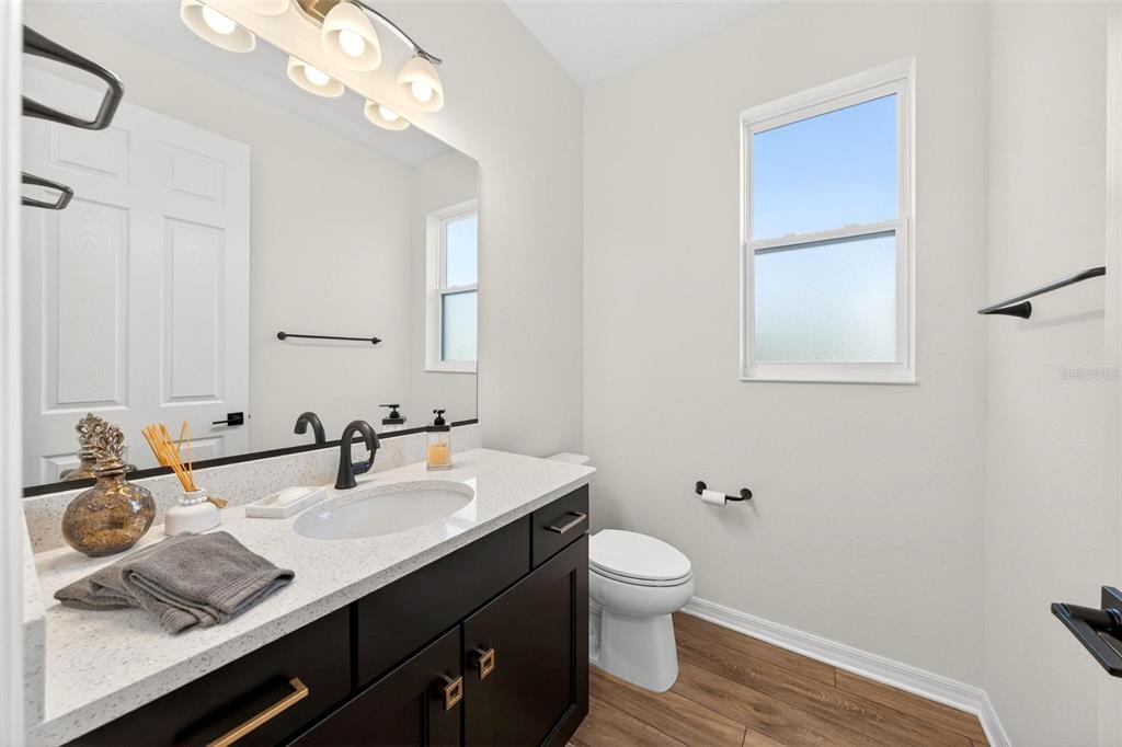 9746 Southwest 108th Terrace Road Ocala, FL 34481 - Photo 67 of 99 a bathroom with a granite countertop sink toilet and mirror