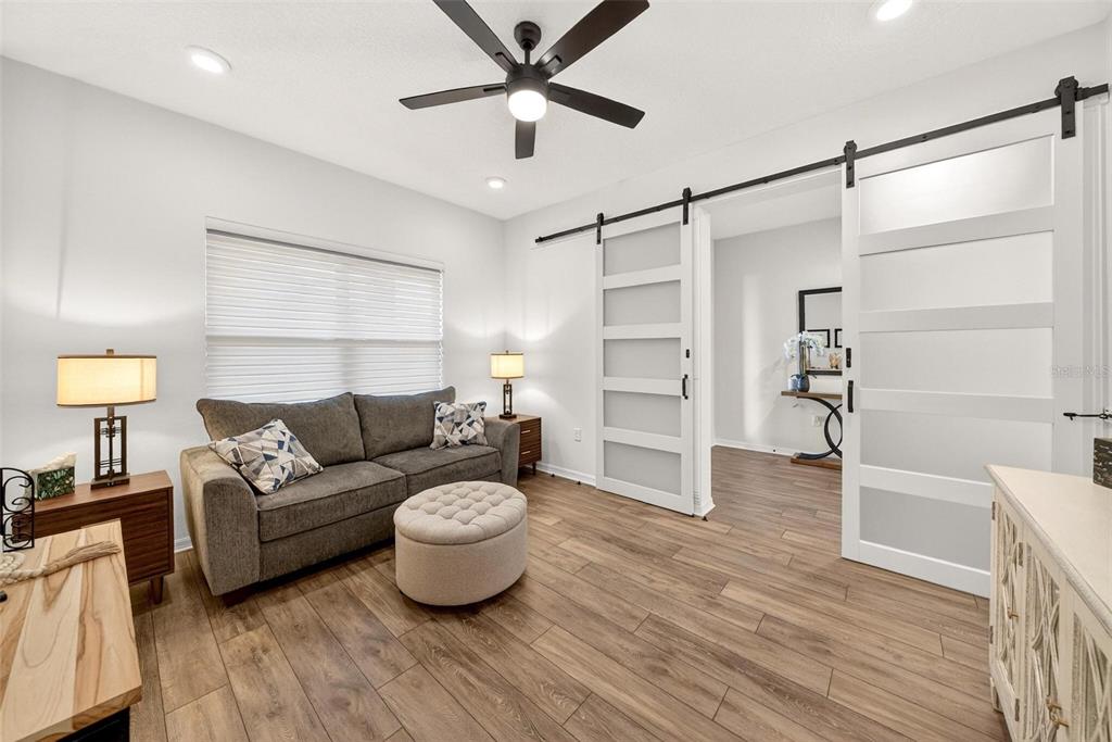 9746 Southwest 108th Terrace Road Ocala, FL 34481 - Photo 71 of 99 a living room with furniture and a wooden floor