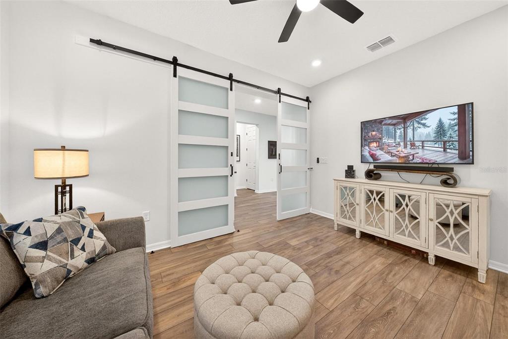 9746 Southwest 108th Terrace Road Ocala, FL 34481 - Photo 72 of 99 a living room with furniture and a flat screen tv