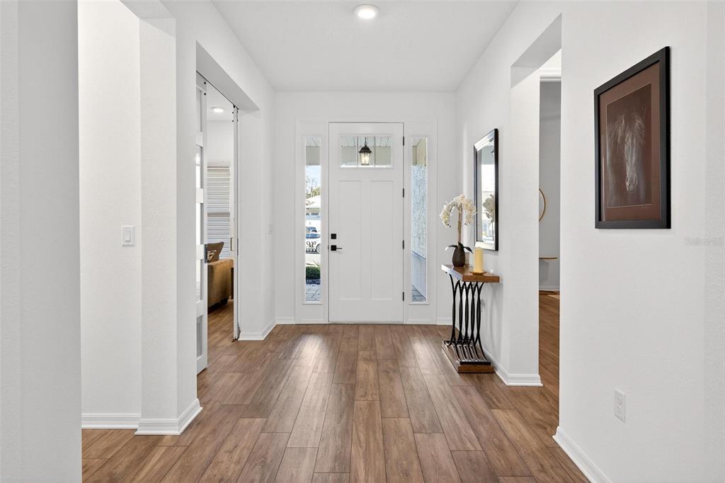 9746 Southwest 108th Terrace Road Ocala, FL 34481 - Photo 9 of 99 a view of a hallway with wooden floor and closet area