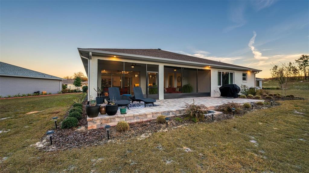 9746 Southwest 108th Terrace Road Ocala, FL 34481 - Photo 95 of 99 a view of a house with backyard porch and sitting area