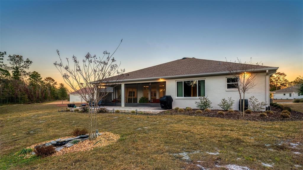 9746 Southwest 108th Terrace Road Ocala, FL 34481 - Photo 96 of 99 a front view of house with yard outdoor seating and barbeque oven