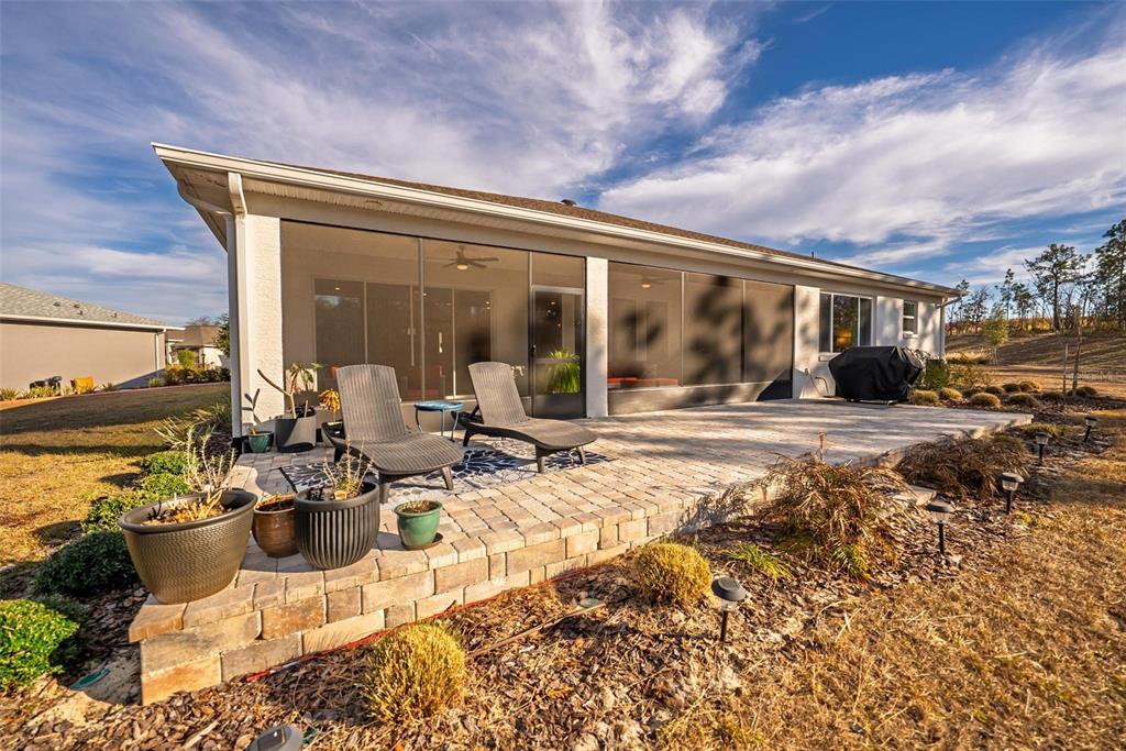 9746 Southwest 108th Terrace Road Ocala, FL 34481 - Photo 99 of 99 a view of a patio with couches chairs and wooden floor