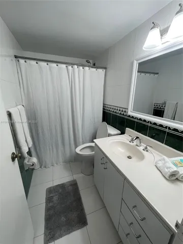 a view of a garden with a bench in front of house