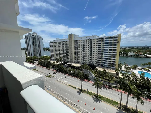 a view of a pathway both side of grassy field with shrub