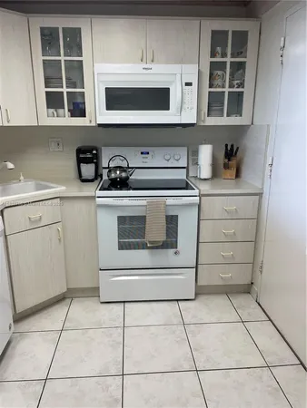 a kitchen with a refrigerator and a cabinets
