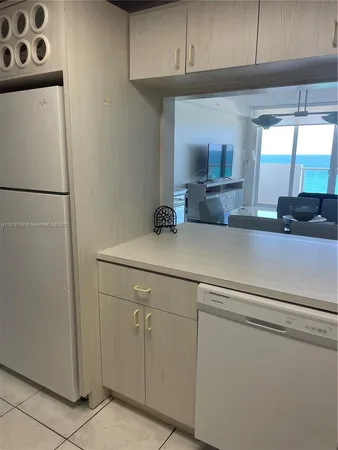 a room with a chair and potted plant on the table