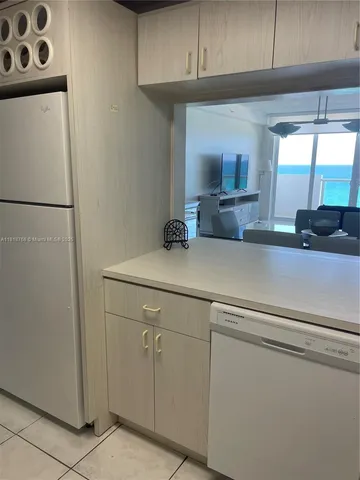 a room with a chair and potted plant on the table