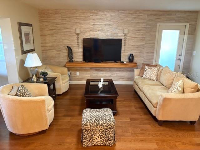 404 Feltham Trail, Unit B Sun City Center, FL 33573 - Photo 11 of 59 a living room with furniture and a flat screen tv
