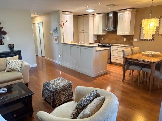 404 Feltham Trail, Unit B Sun City Center, FL 33573 - Photo 14 of 59 a living room with furniture and a wooden floor