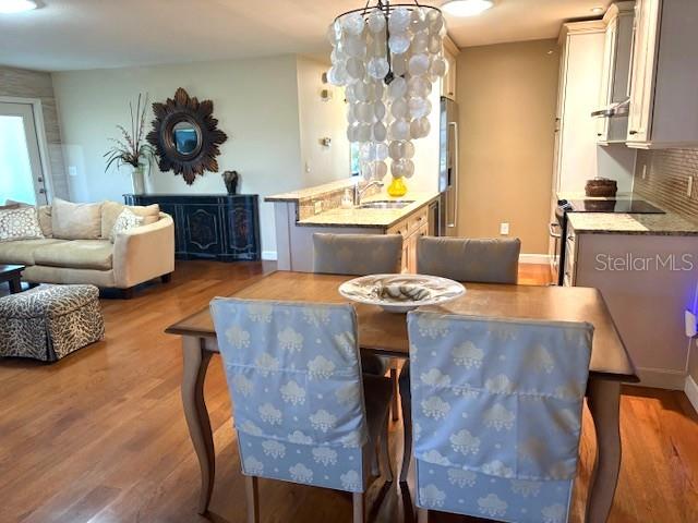 404 Feltham Trail, Unit B Sun City Center, FL 33573 - Photo 15 of 59 a view of a dining room with furniture and wooden floor