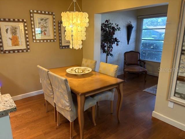 404 Feltham Trail, Unit B Sun City Center, FL 33573 - Photo 16 of 59 a view of a dining room with furniture and wooden floor