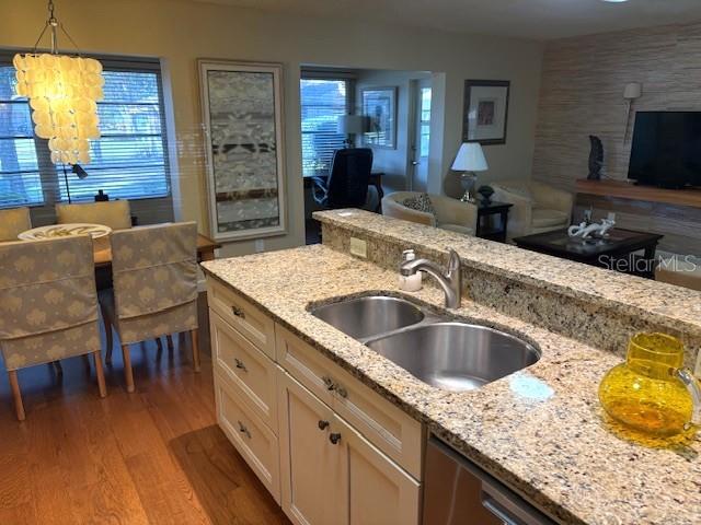 404 Feltham Trail, Unit B Sun City Center, FL 33573 - Photo 20 of 59 a kitchen with granite countertop a sink a counter top space and stainless steel appliances