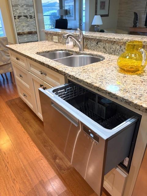 404 Feltham Trail, Unit B Sun City Center, FL 33573 - Photo 21 of 59 a kitchen with granite countertop a sink and a stove