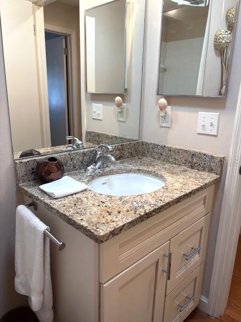 404 Feltham Trail, Unit B Sun City Center, FL 33573 - Photo 30 of 59 a bathroom with a granite countertop sink and a mirror