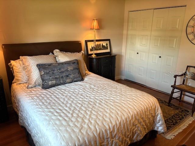 404 Feltham Trail, Unit B Sun City Center, FL 33573 - Photo 32 of 59 a bedroom with a bed and painting on the wall