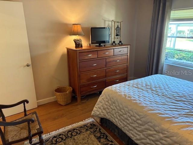 404 Feltham Trail, Unit B Sun City Center, FL 33573 - Photo 34 of 59 a bedroom with a bed and flat screen tv